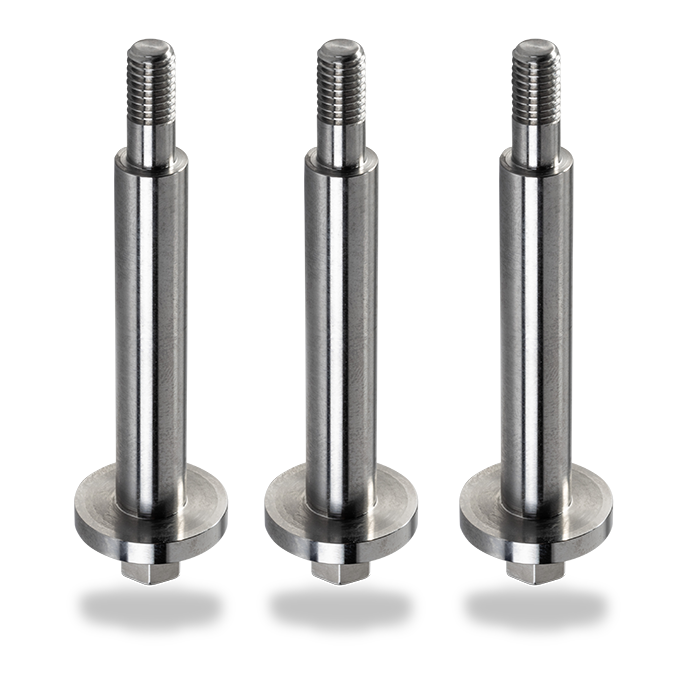 Three shiny silver machined parts.