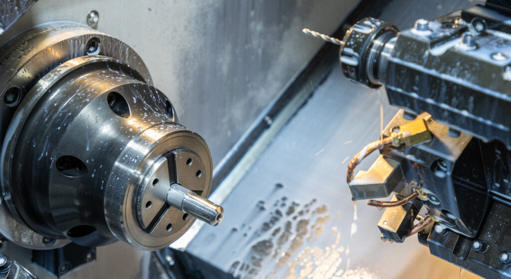 A close-up of two drilling pieces in a machine.