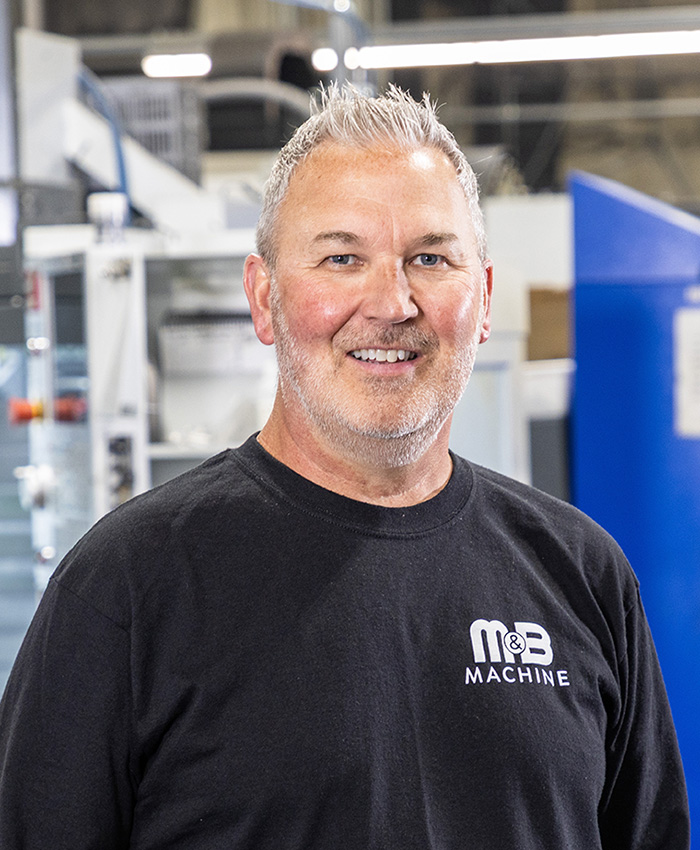 A picture of a man smiling and looking at the camera.